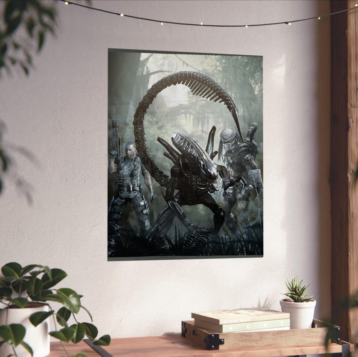 Aliens vs. Predator 2010 alien promo art unframed on a white wall above a desk