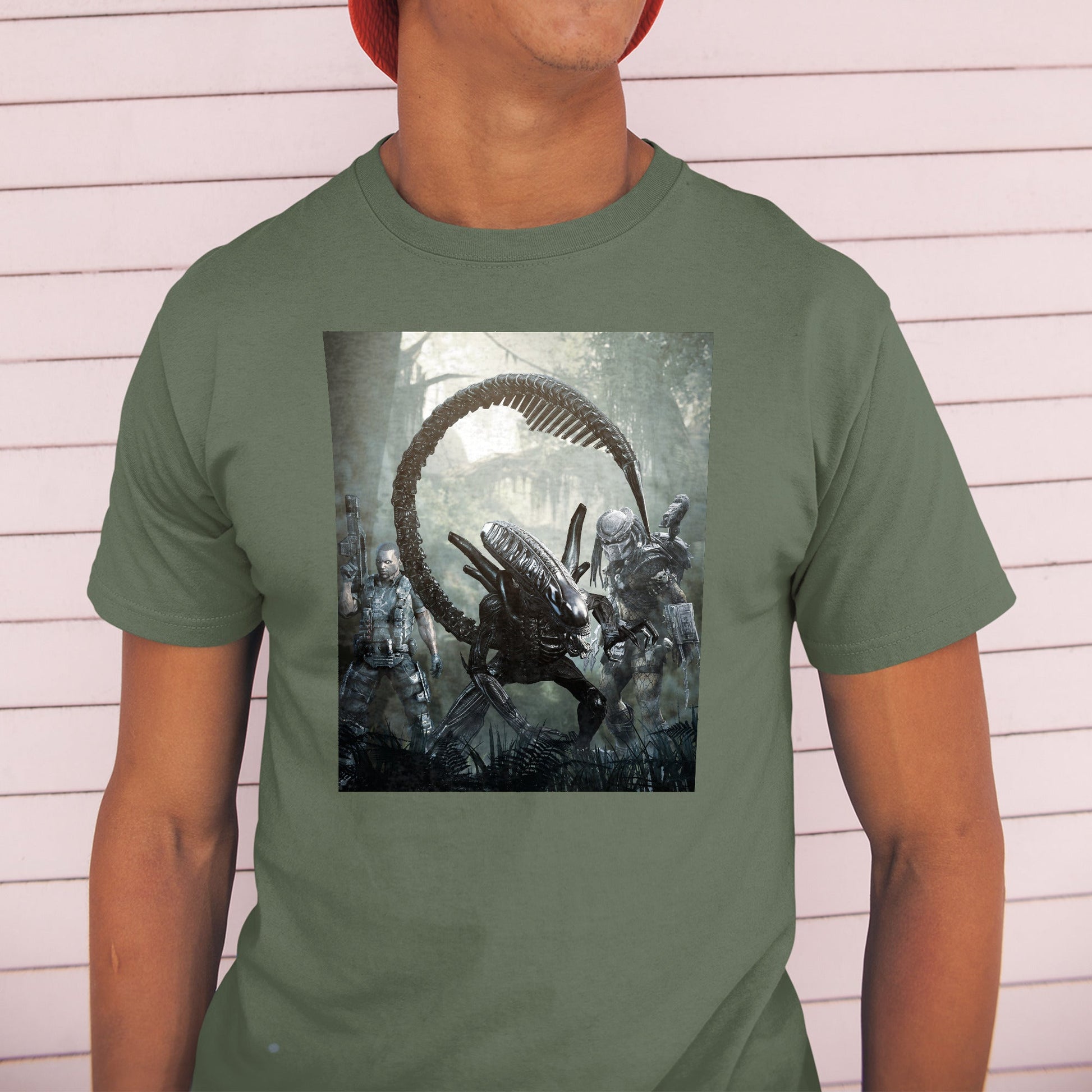 Aliens vs. Predator alien promo art tee worn by a model in a cap, green