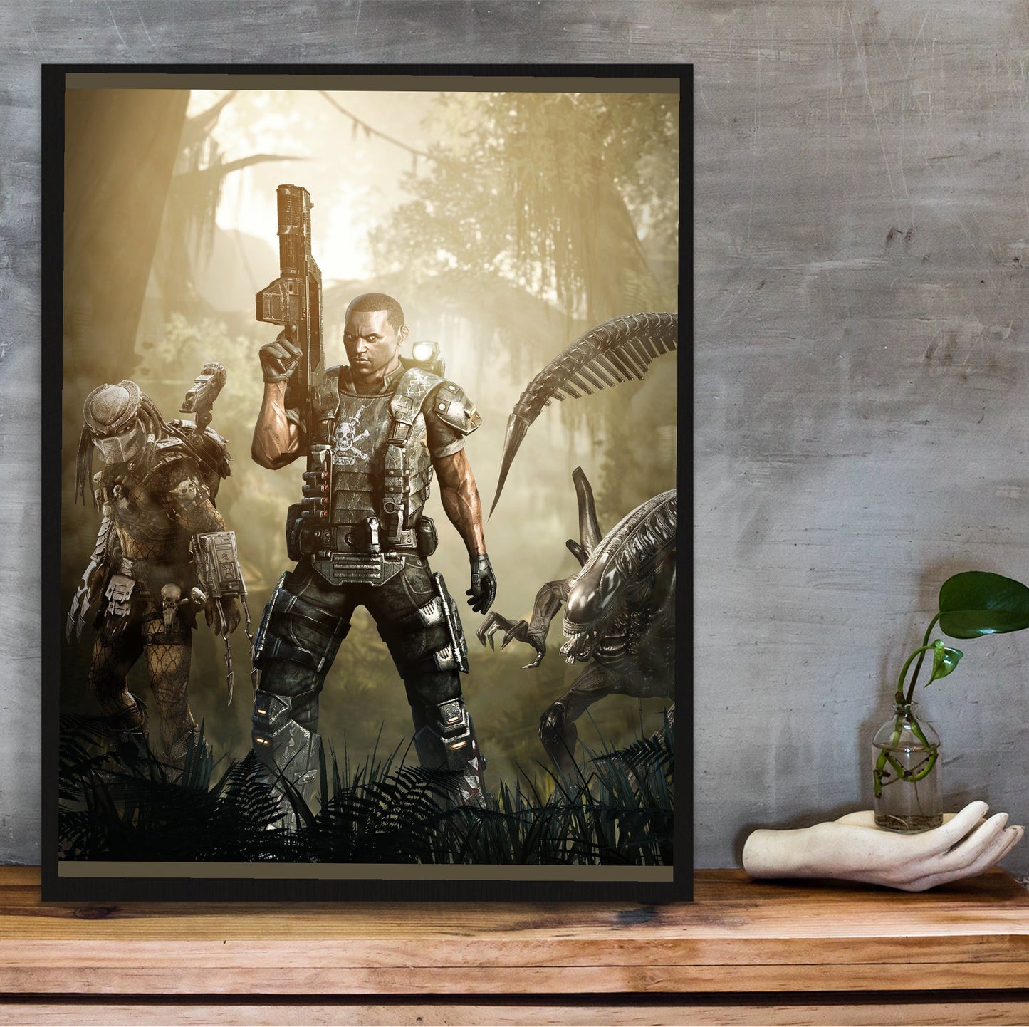 Aliens vs. Predator 2010 colonial marine promo art in a black frame on a wooden shelf against concrete
