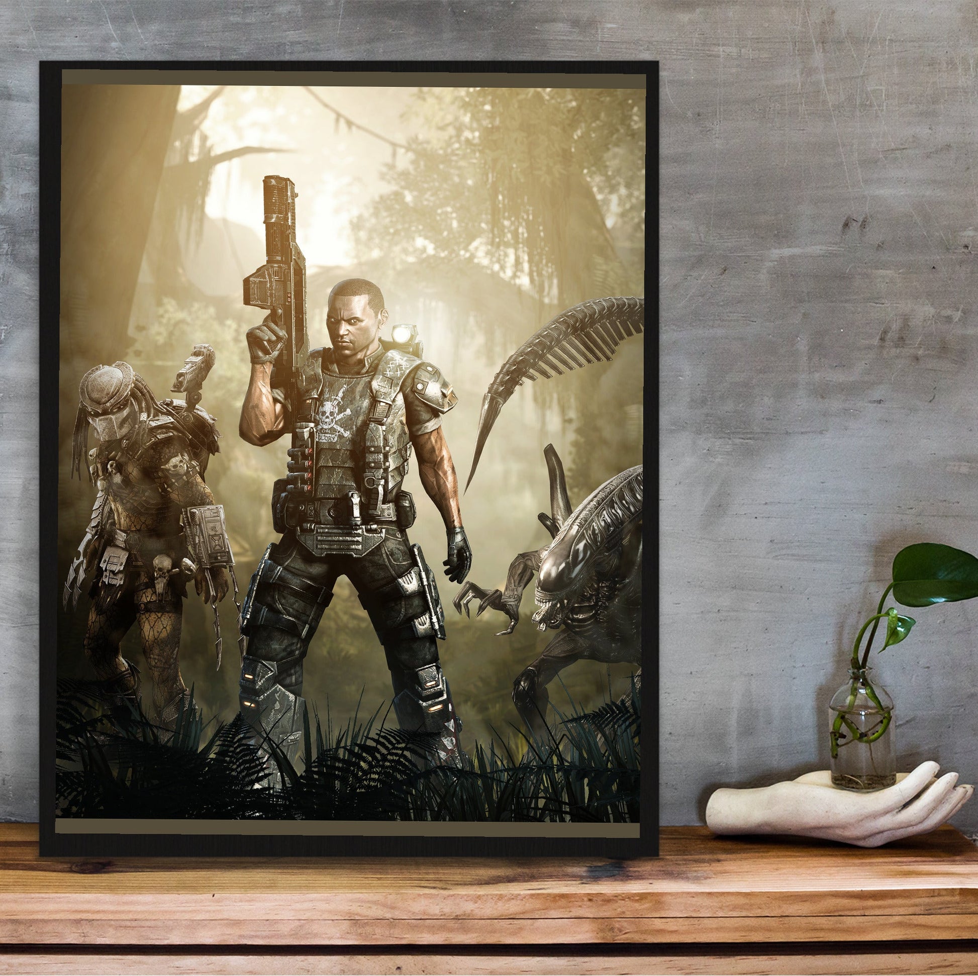 Aliens vs. Predator 2010 colonial marine promo art in a black frame on a wooden shelf against concrete
