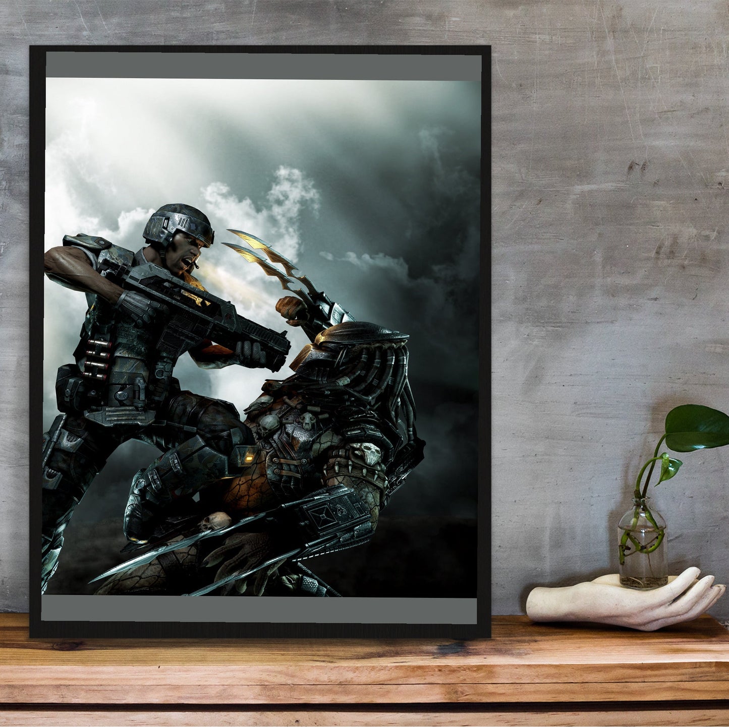 Aliens vs. Predator 2010 marketing art by Mike Man in a black frame on a wooden shelf against concrete