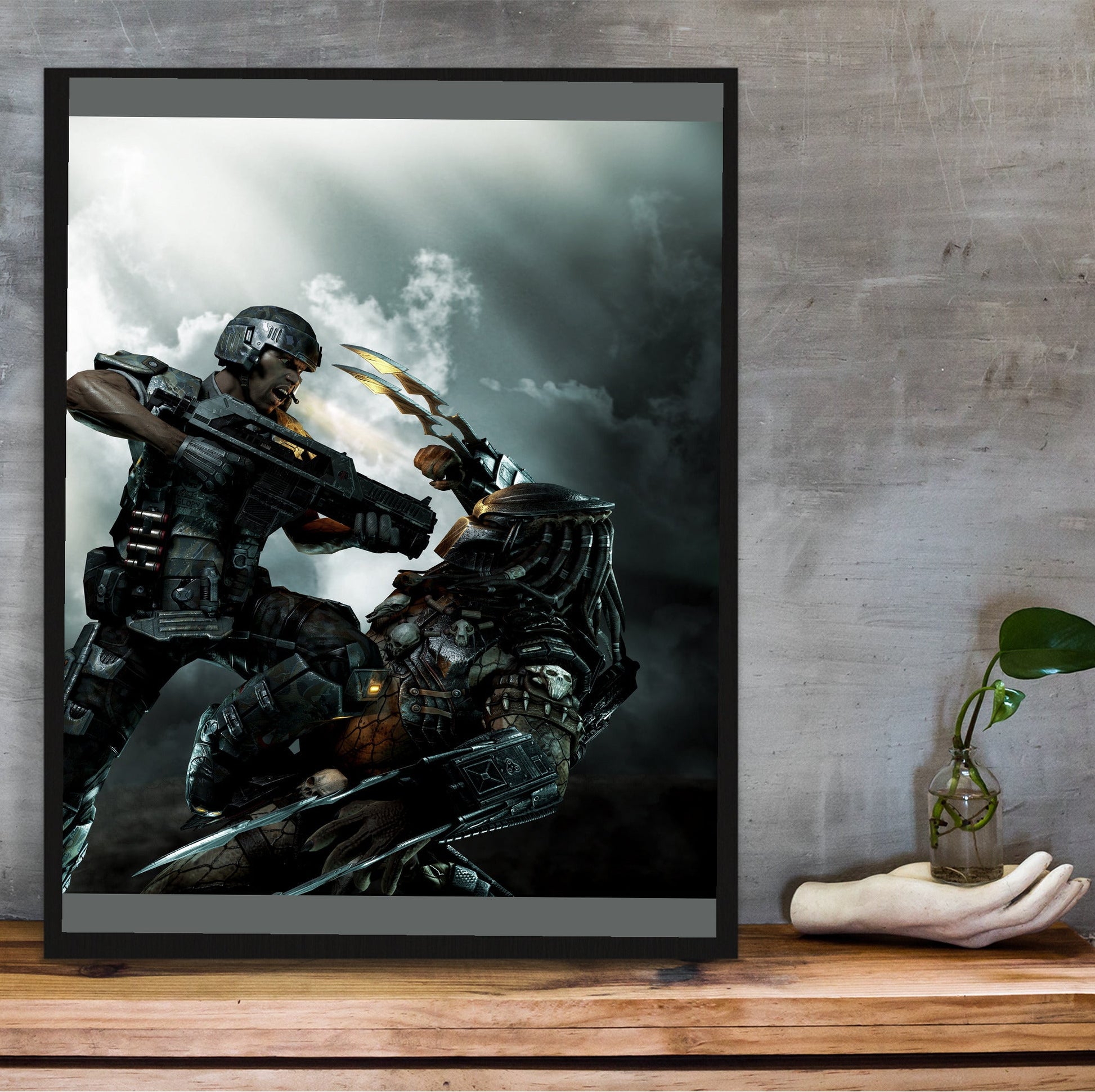 Aliens vs. Predator 2010 marketing art by Mike Man in a black frame on a wooden shelf against concrete
