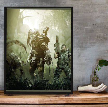 Aliens vs. Predator 2010 predator promo art in a black frame on a wooden shelf against concrete