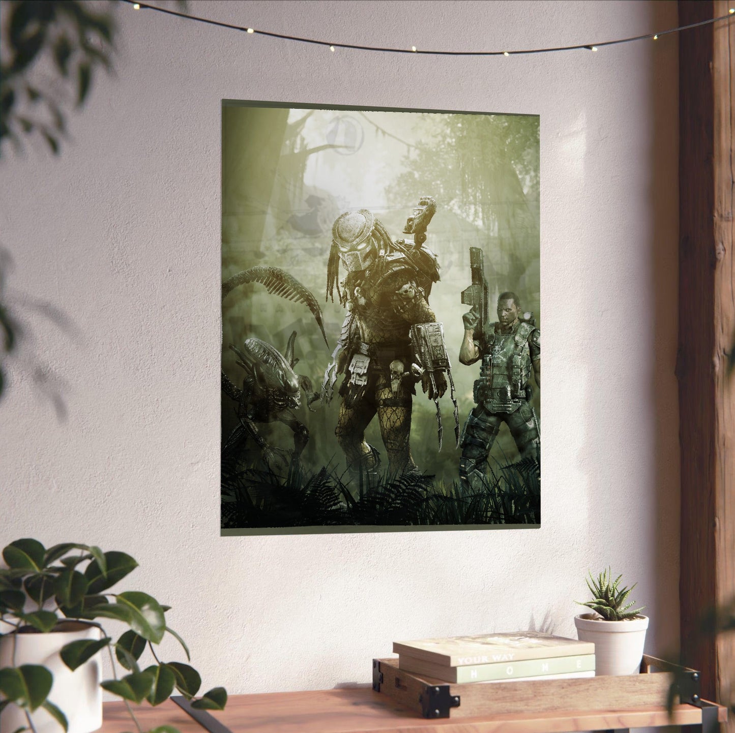 Aliens vs. Predator 2010 predator promo art unframed on a white wall above a desk
