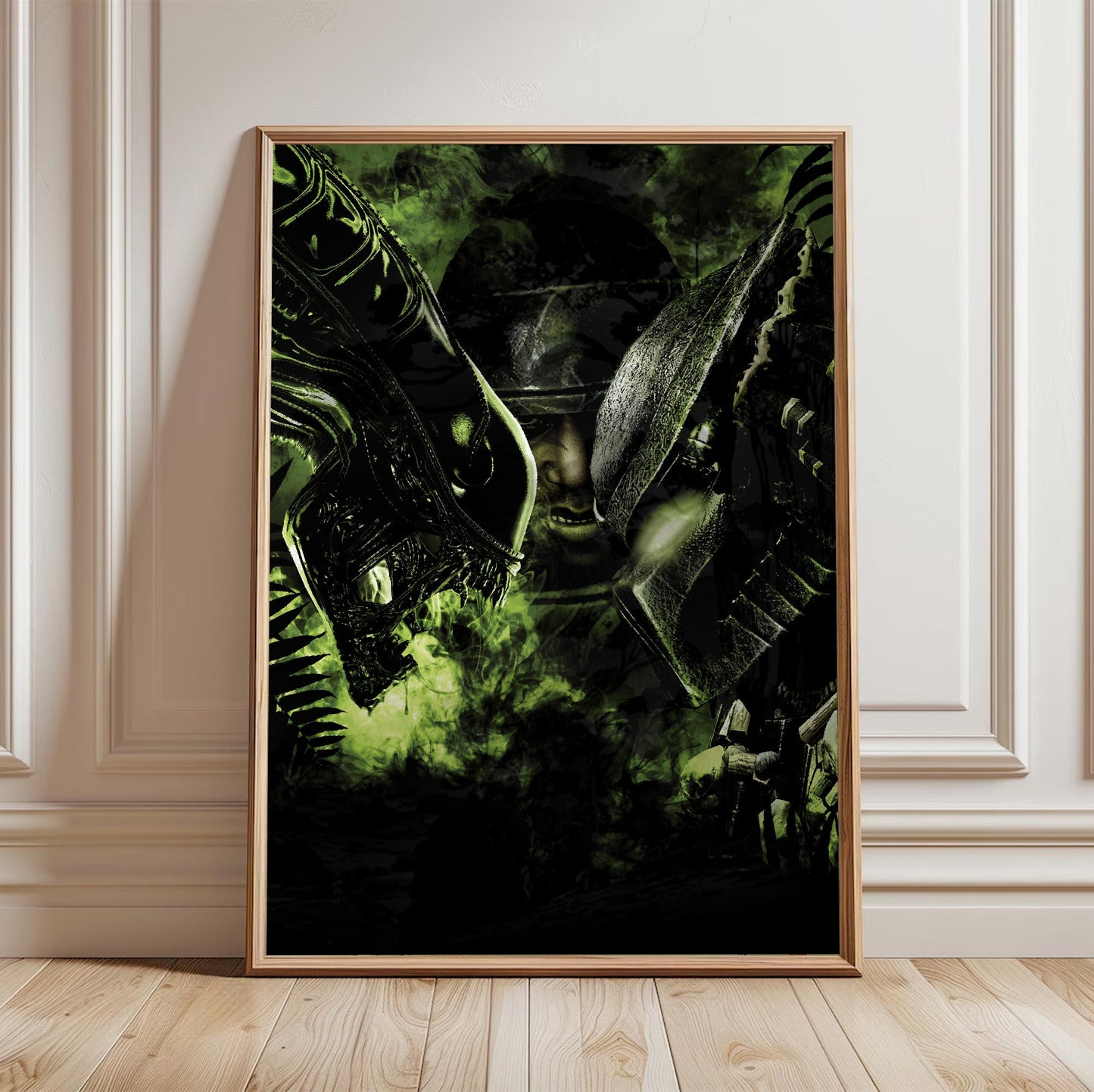 Aliens vs. Predator 2010 promotional art in a light oak frame leaning against a white wall