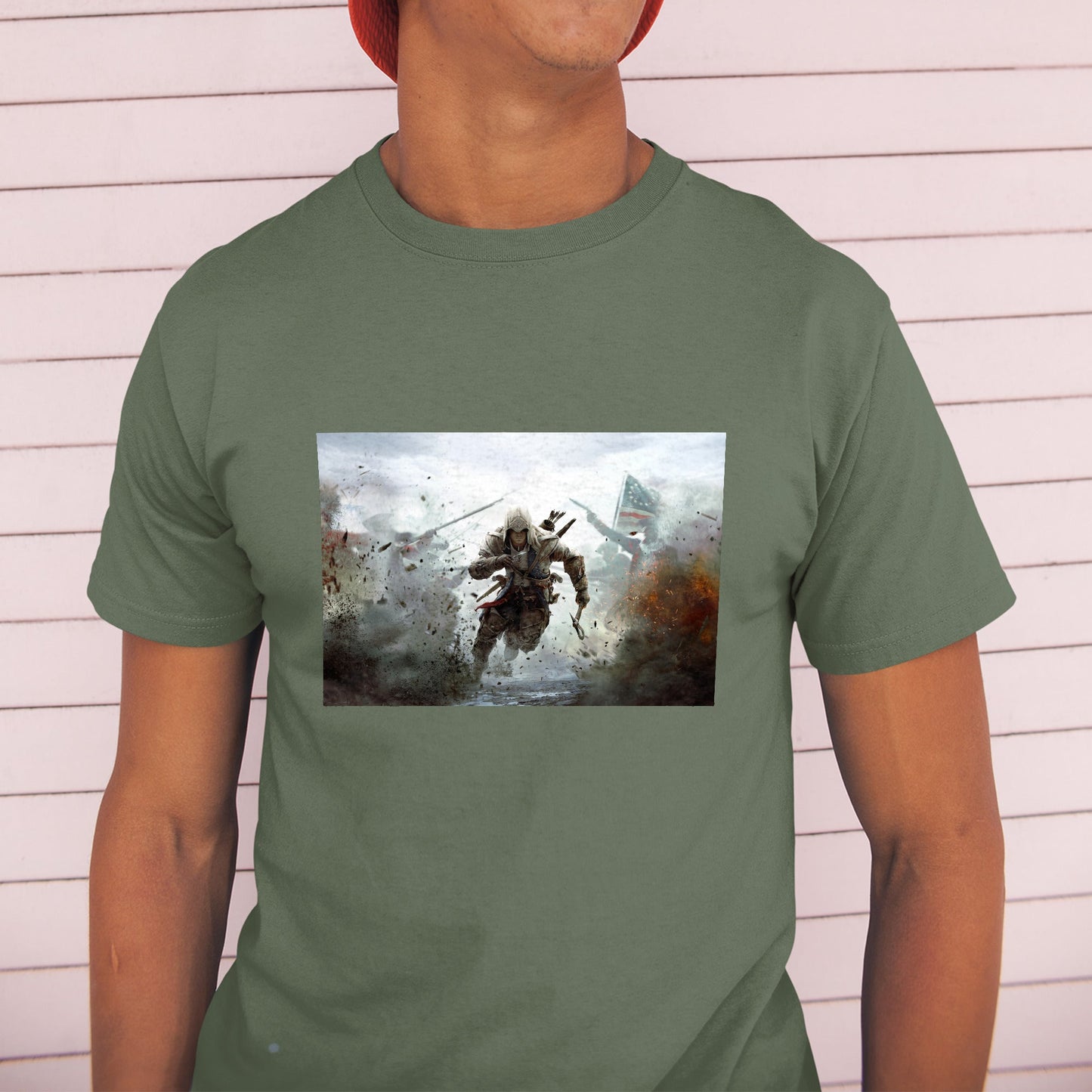 Assassin's Creed III battlefield promo art tee worn by a model in a cap, green