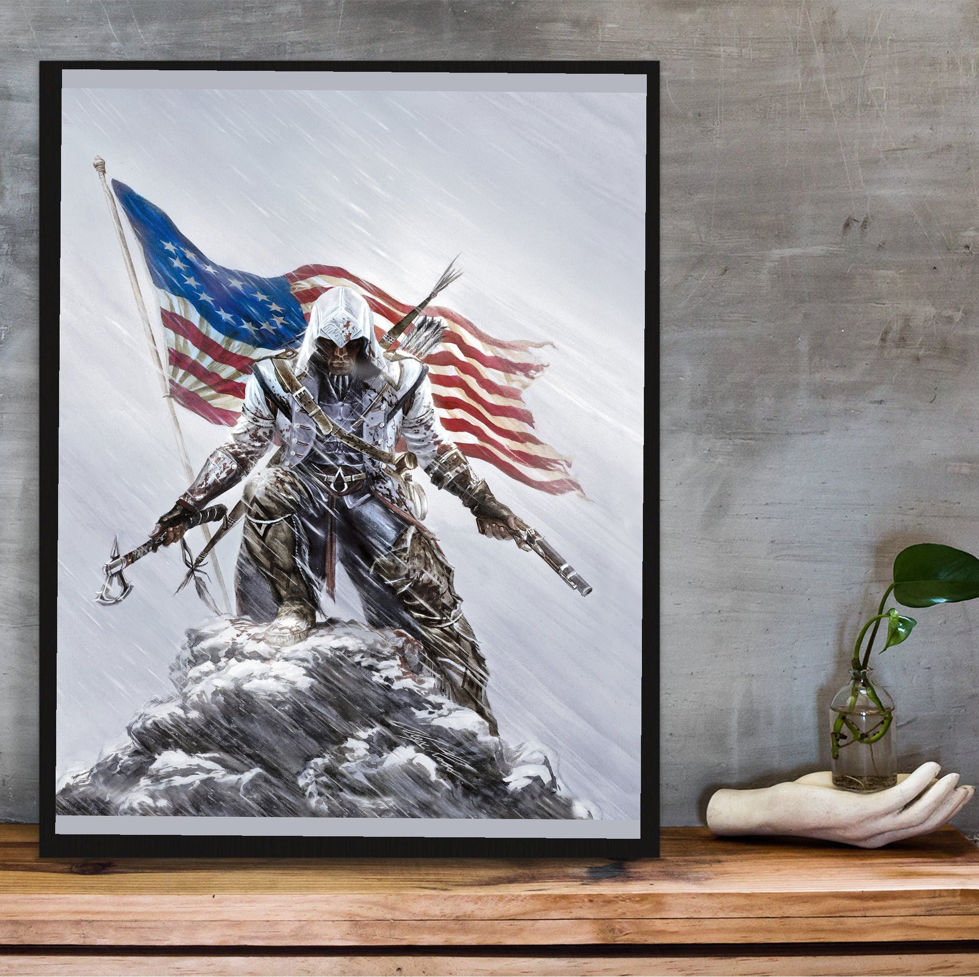 Assassin's Creed III Connor illustration by Alex Ross in a black frame on a wooden shelf against concrete