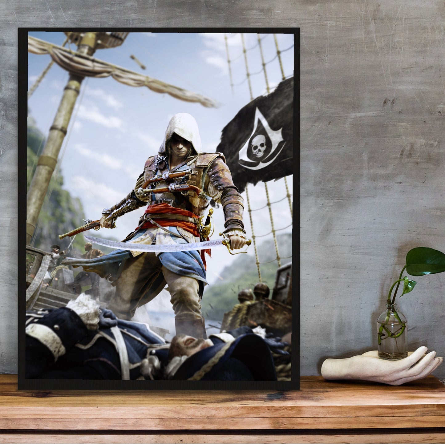 Assassin's Creed IV Black Flag box art in a black frame on a wooden shelf against concrete