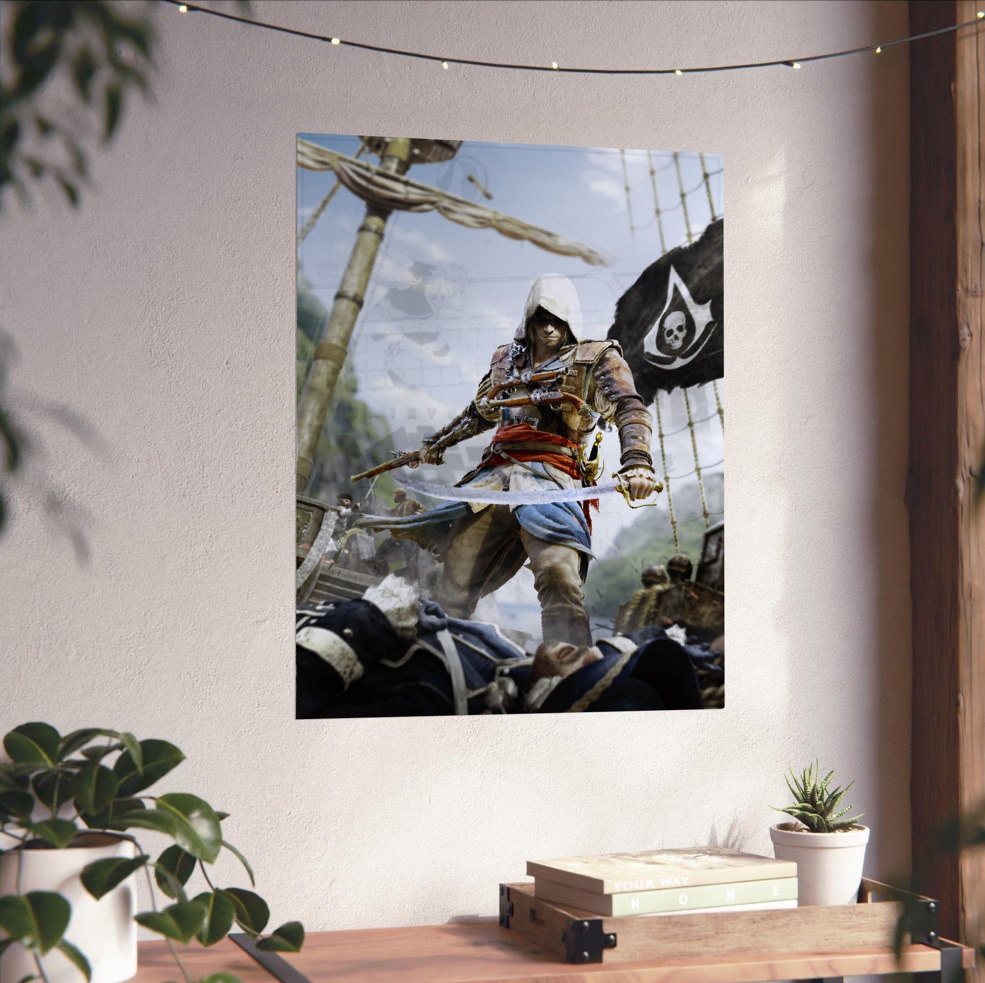 Assassin's Creed IV Black Flag box art unframed on a white wall above a desk