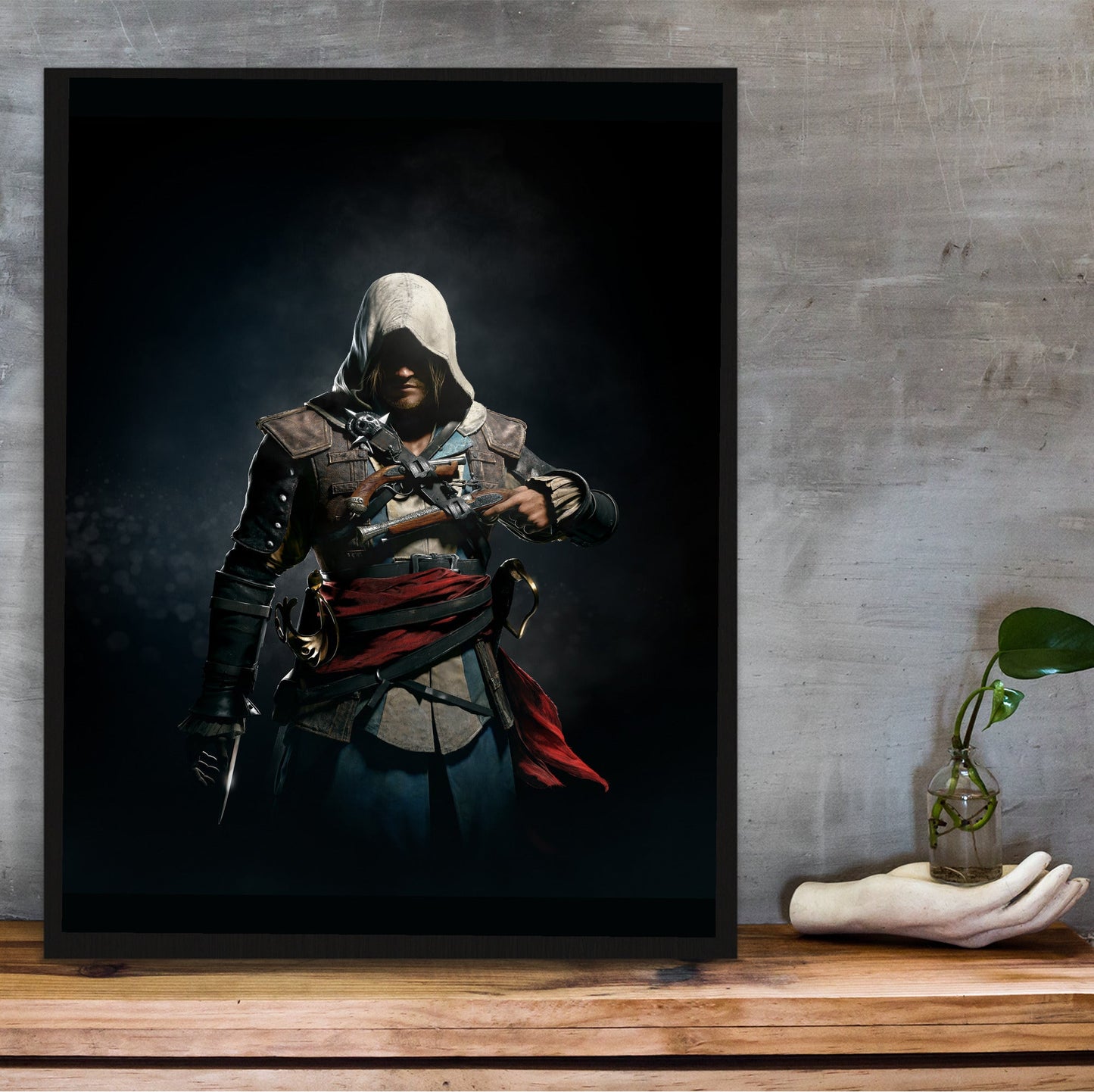Assassin's Creed IV Black Flag Edward Kenway art in a black frame on a wooden shelf against concrete