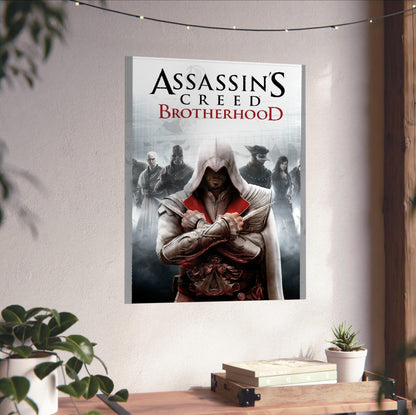 Assassin's Creed Brotherhood cover art unframed on a white wall above a desk