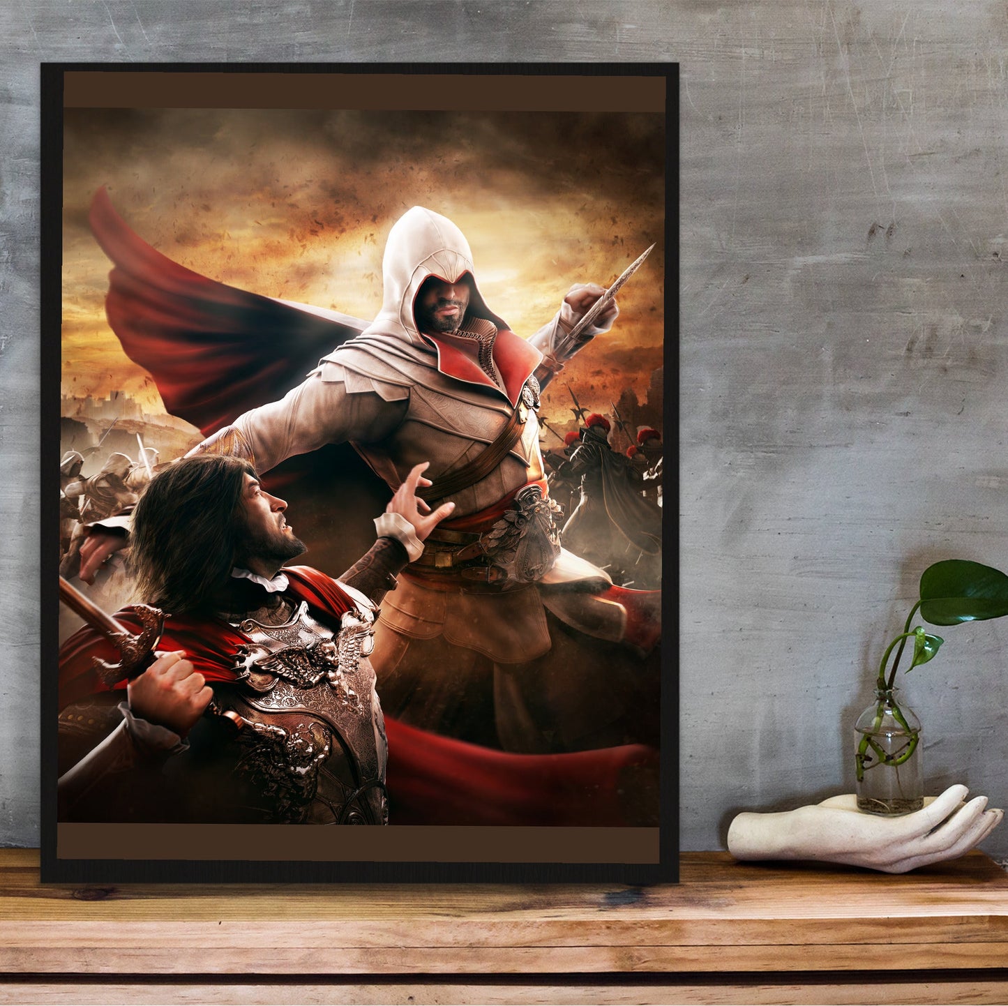Assassin's Creed Brotherhood Ezio vs Cesare Borgia art in a black frame on a wooden shelf against concrete