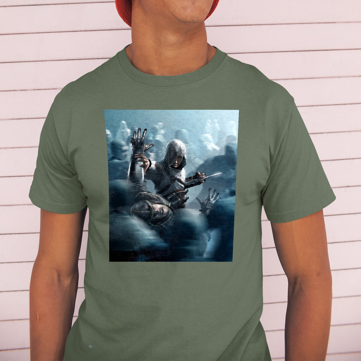Assassin's Creed key visual tee worn by a model in a cap, green