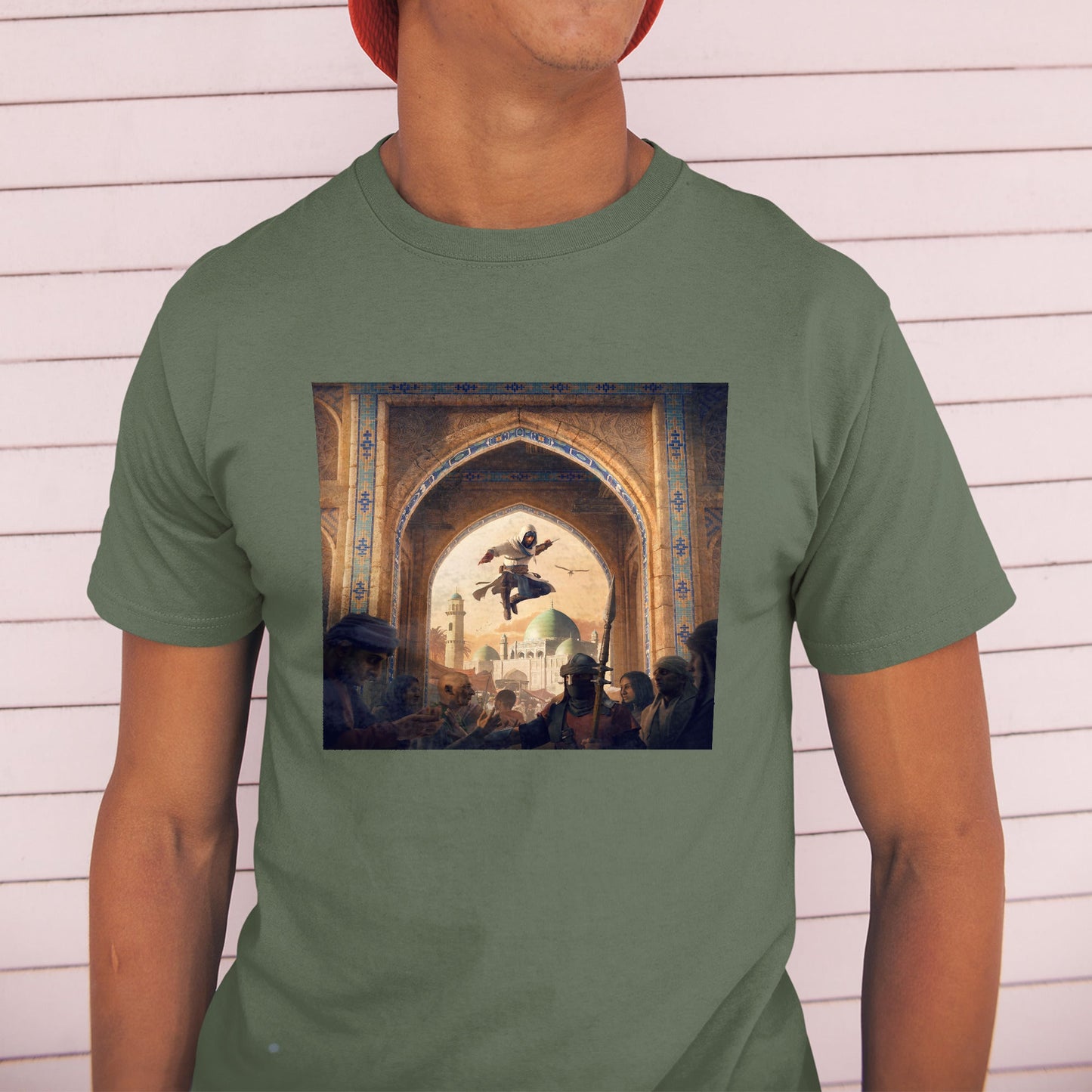 Assassin's Creed Mirage announcement key art tee worn by a model in a cap, green