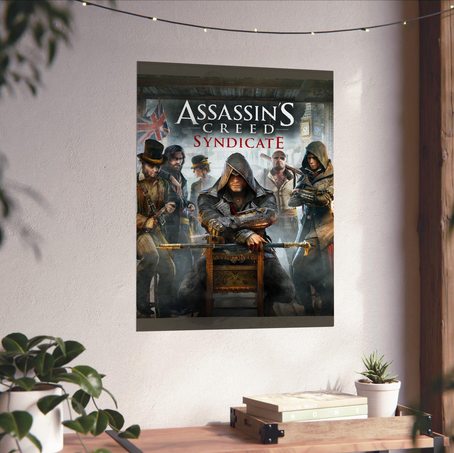 Assassin's Creed Syndicate cover art with logo unframed on a white wall above a desk