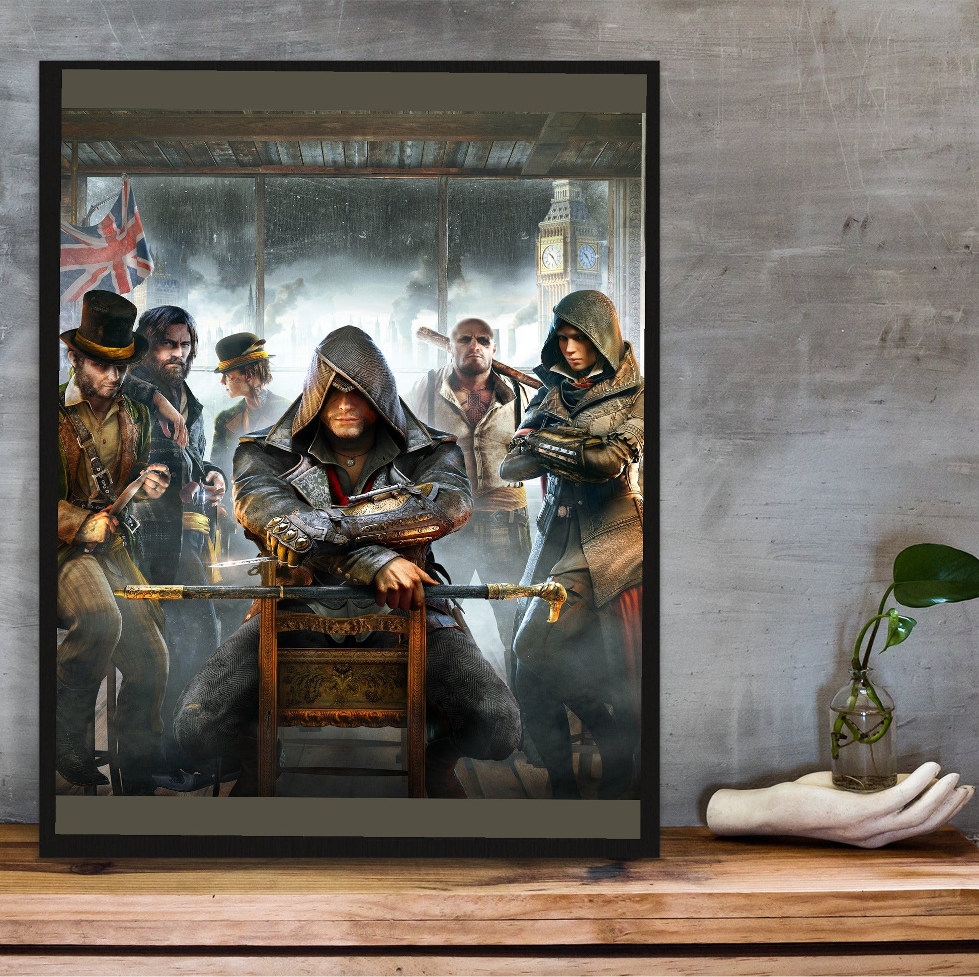 Assassin's Creed Syndicate cover art in a black frame on a wooden shelf against concrete