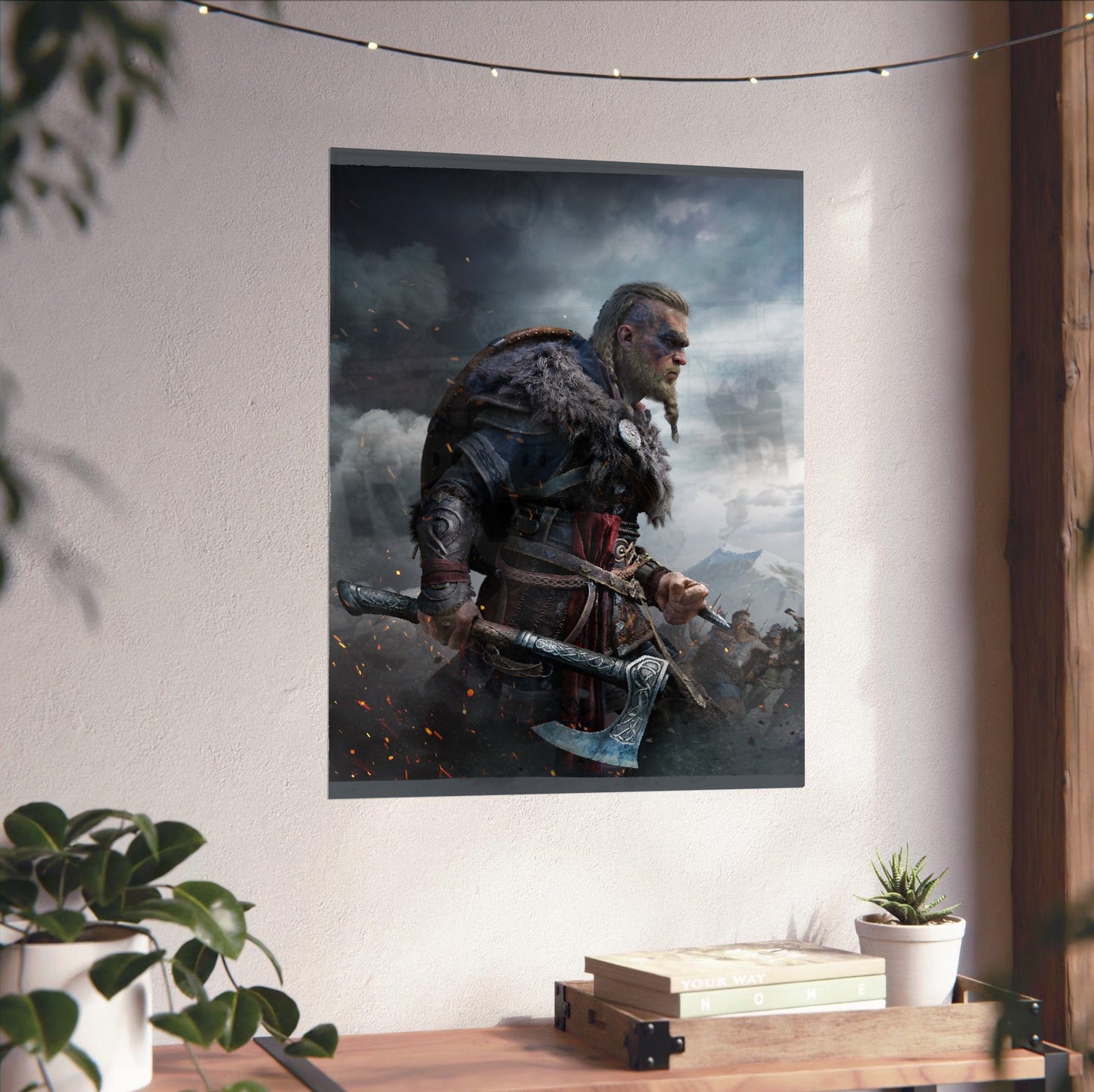 Assassin's Creed Valhalla Ultimate Edition key art unframed on a white wall above a desk