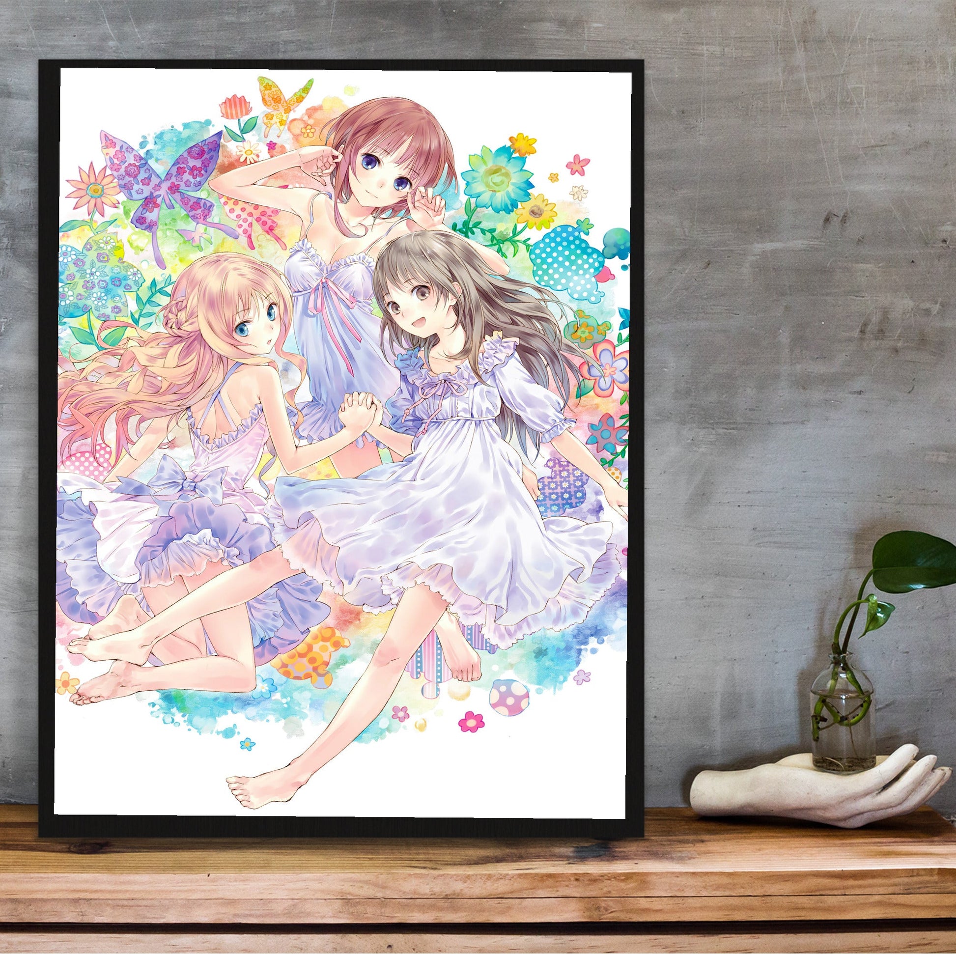 Atelier Arland Series Deluxe Pack Limited Illustration by Mel Kishida in a black frame on a wooden shelf against concrete