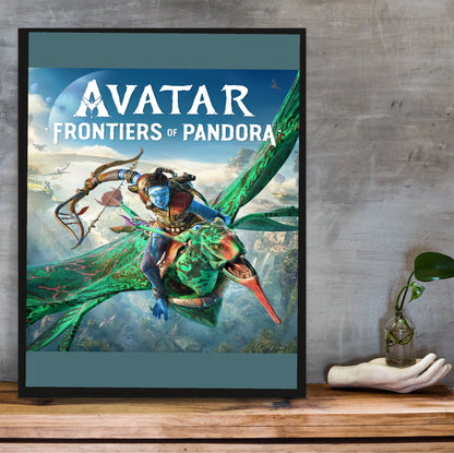 Avatar Frontiers of Pandora Official Cover Art in a black frame on a wooden shelf against concrete