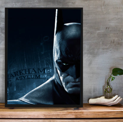 Batman Arkham Asylum Batman promo art poster in a black frame on a wooden shelf against concrete