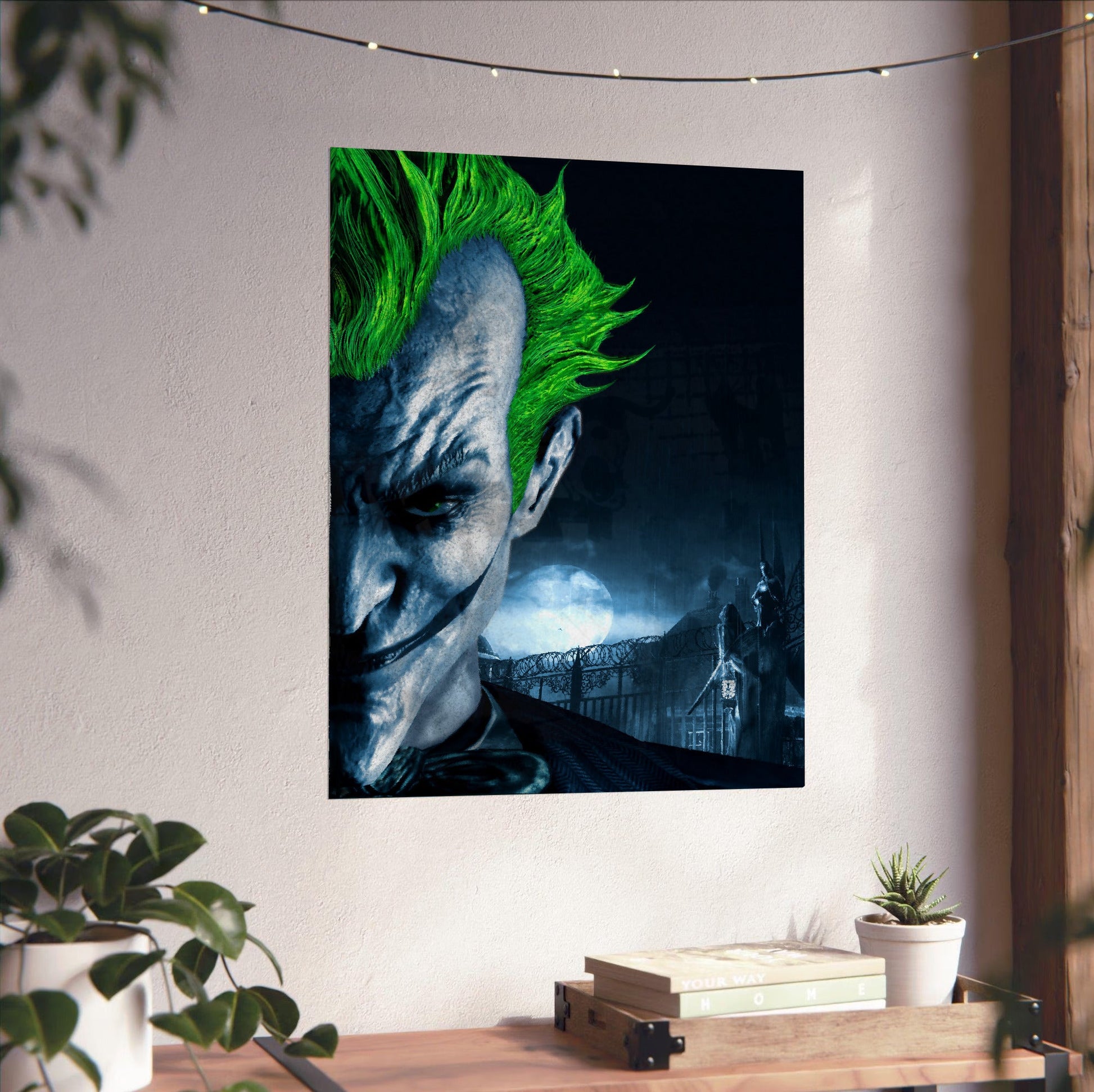 Batman Arkham Asylum Joker promo art poster unframed on a white wall above a desk