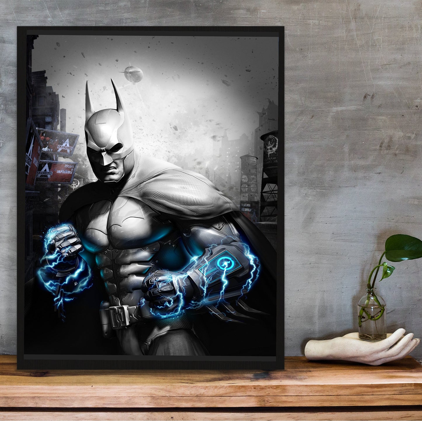 Batman Arkham City Armored Edition key art poster in a black frame on a wooden shelf against concrete