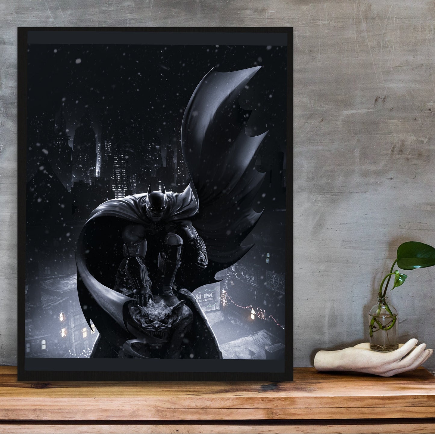 Batman Arkham Origins Batman key art poster in a black frame on a wooden shelf against concrete