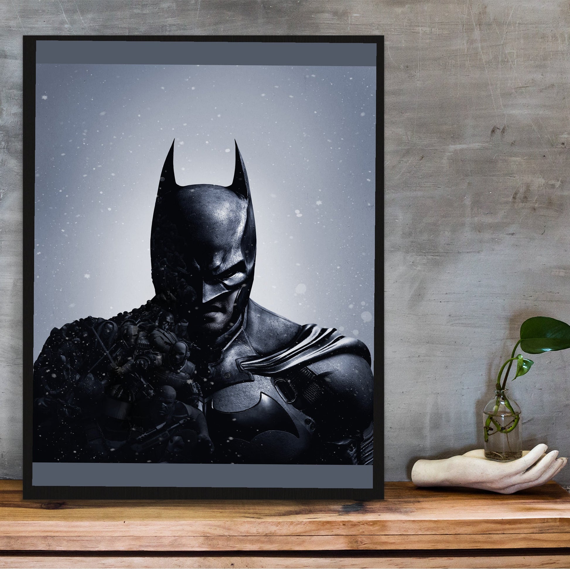 Batman Arkham Origins official cover art poster in a black frame on a wooden shelf against concrete