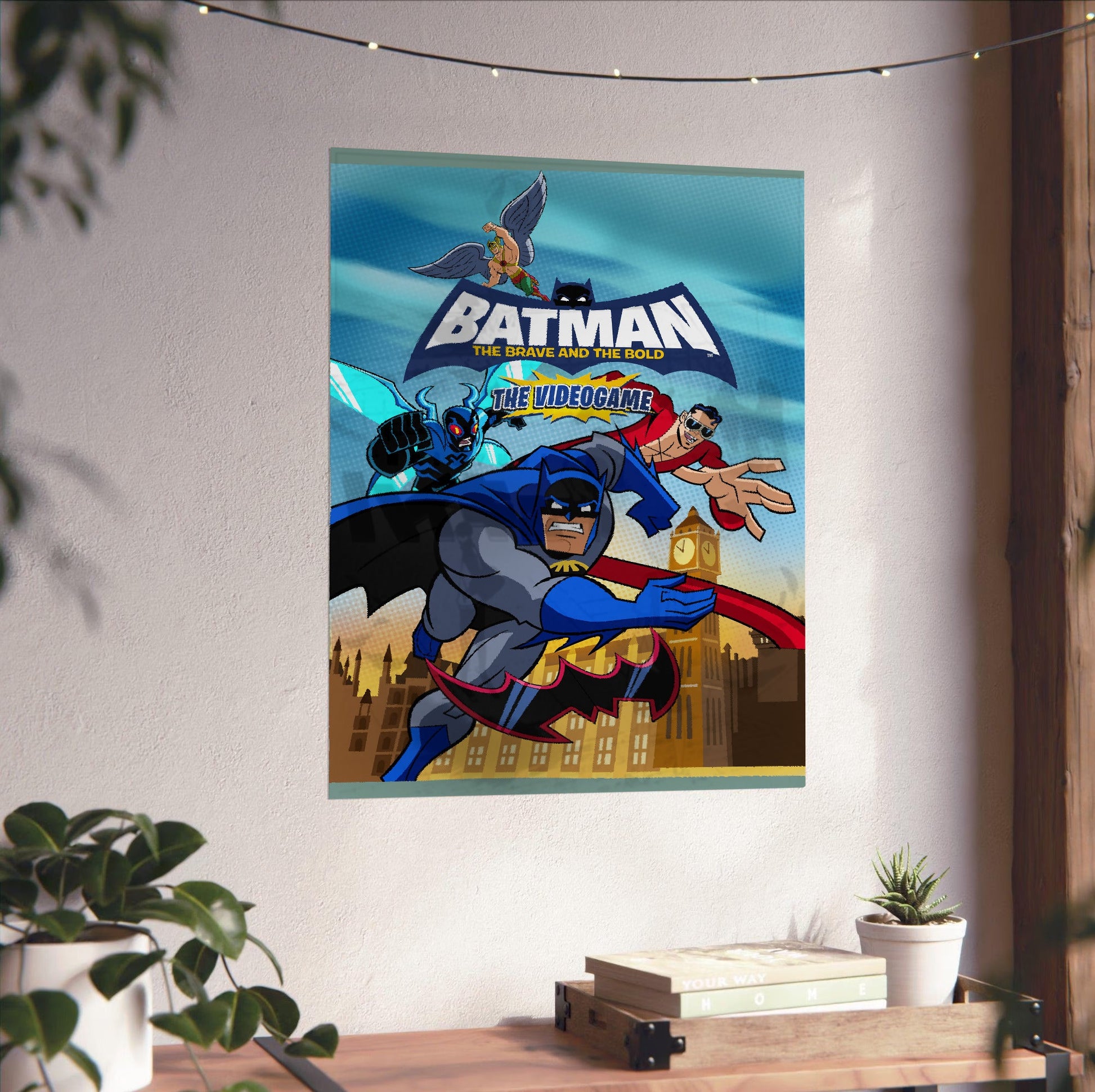 Batman The Brave and the Bold videogame cover art with logo poster unframed on a white wall above a desk