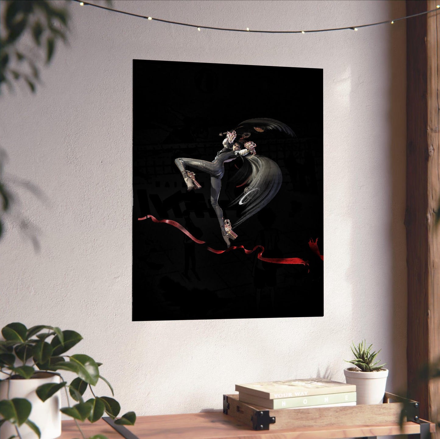 Bayonetta action pose art poster unframed on a white wall above a desk