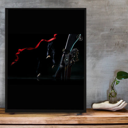 Bayonetta boots and bullets art poster in a black frame on a wooden shelf against concrete