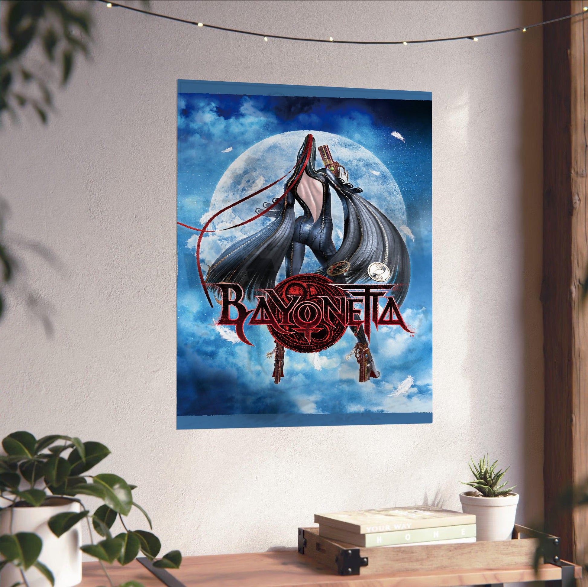 Bayonetta moonlight key art with logo poster unframed on a white wall above a desk