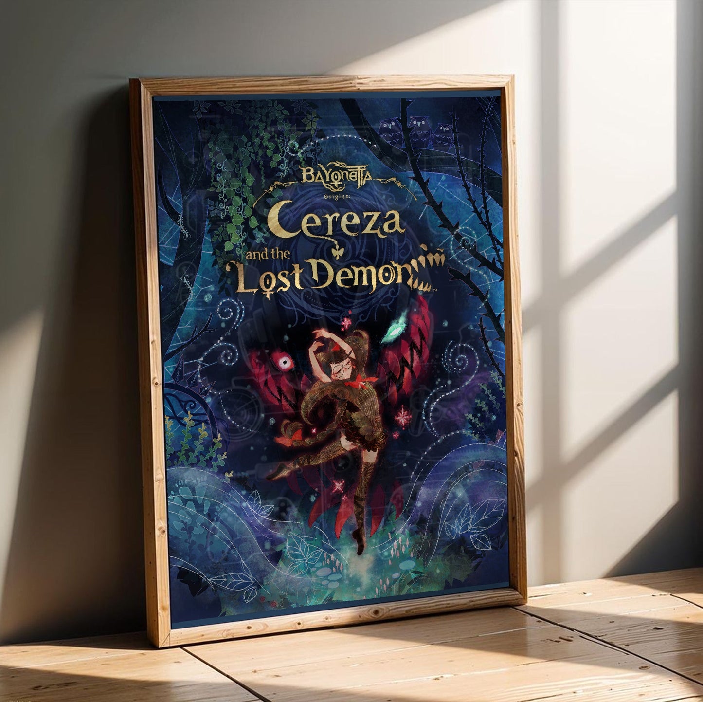 Bayonetta Origins Cereza and the Lost Demon cover art poster in an oak frame leaning on a wooden floor