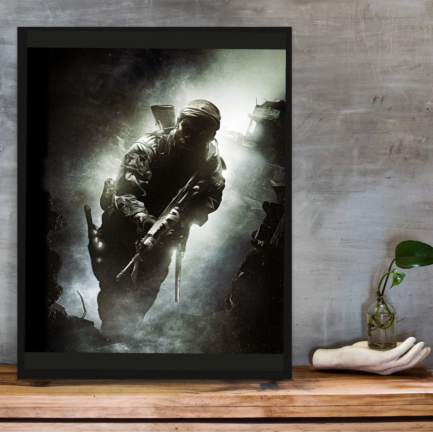 Call of Duty Black Ops key art in a black frame on a wooden shelf against concrete