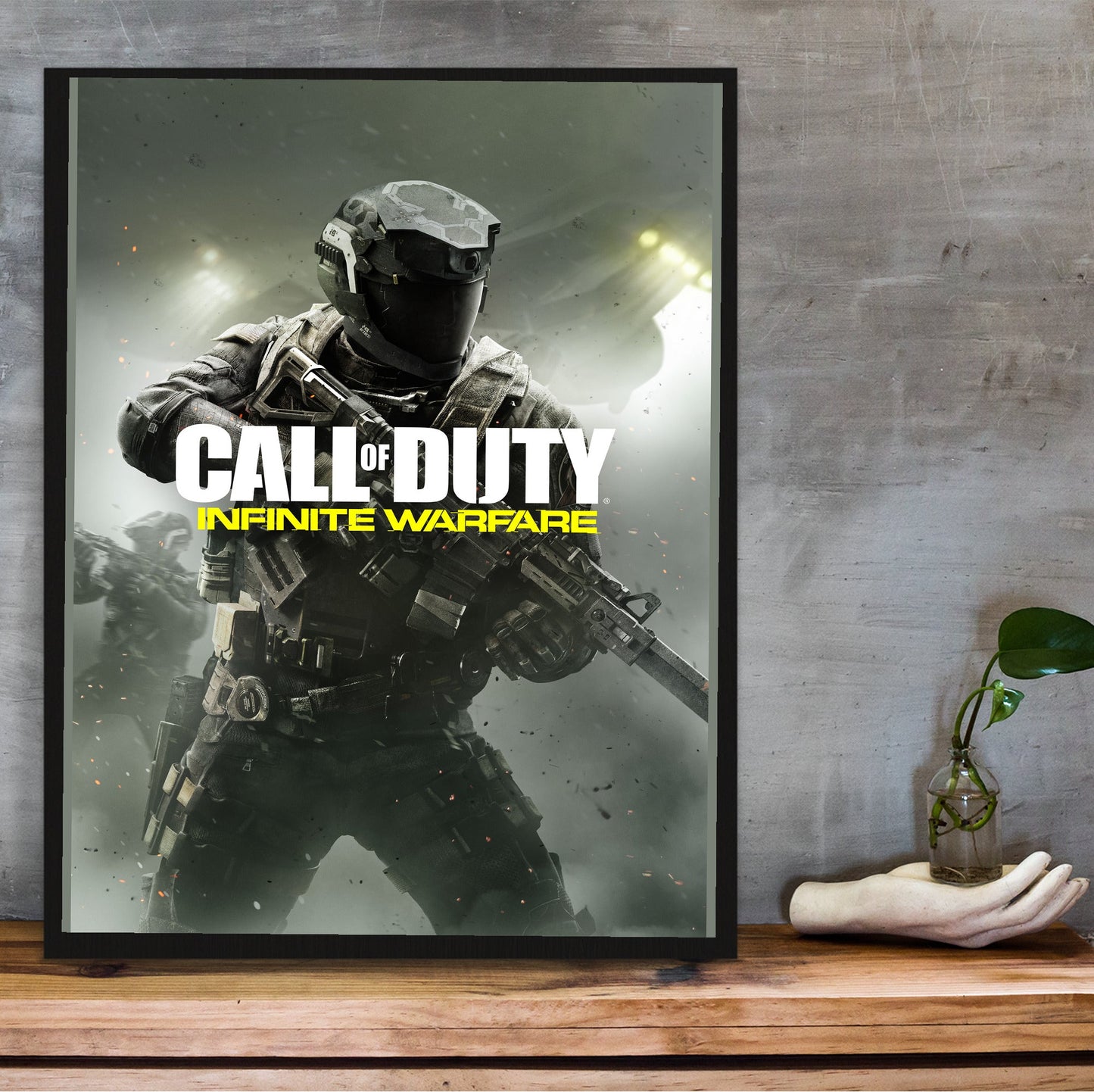 Call of Duty Infinite Warfare key art in a black frame on a wooden shelf against concrete
