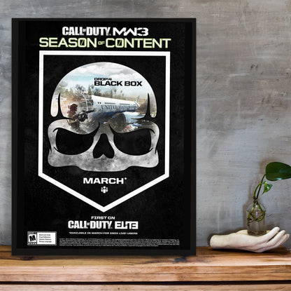 Call of Duty Modern Warfare 3 Black Box season art in a black frame on a wooden shelf against concrete