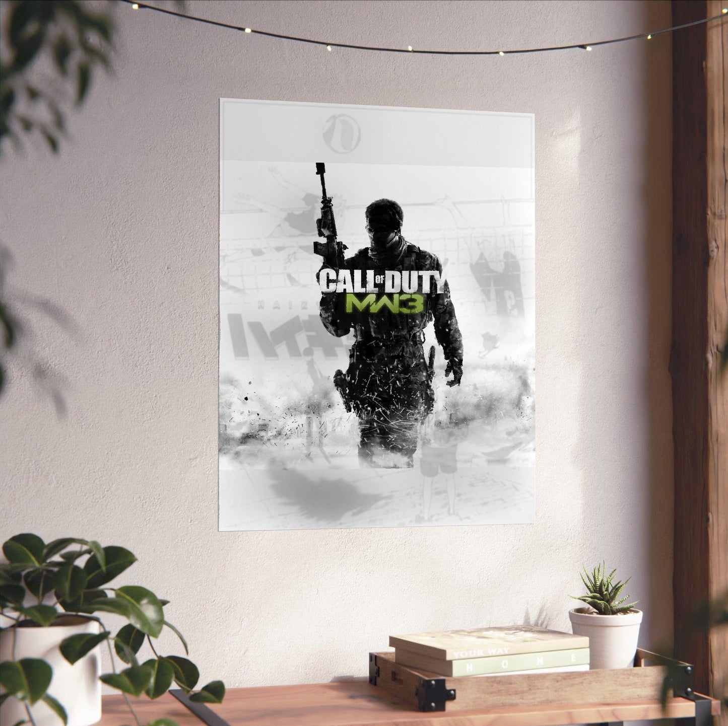 Call of Duty Modern Warfare 3 cover art with logo unframed on a white wall above a desk