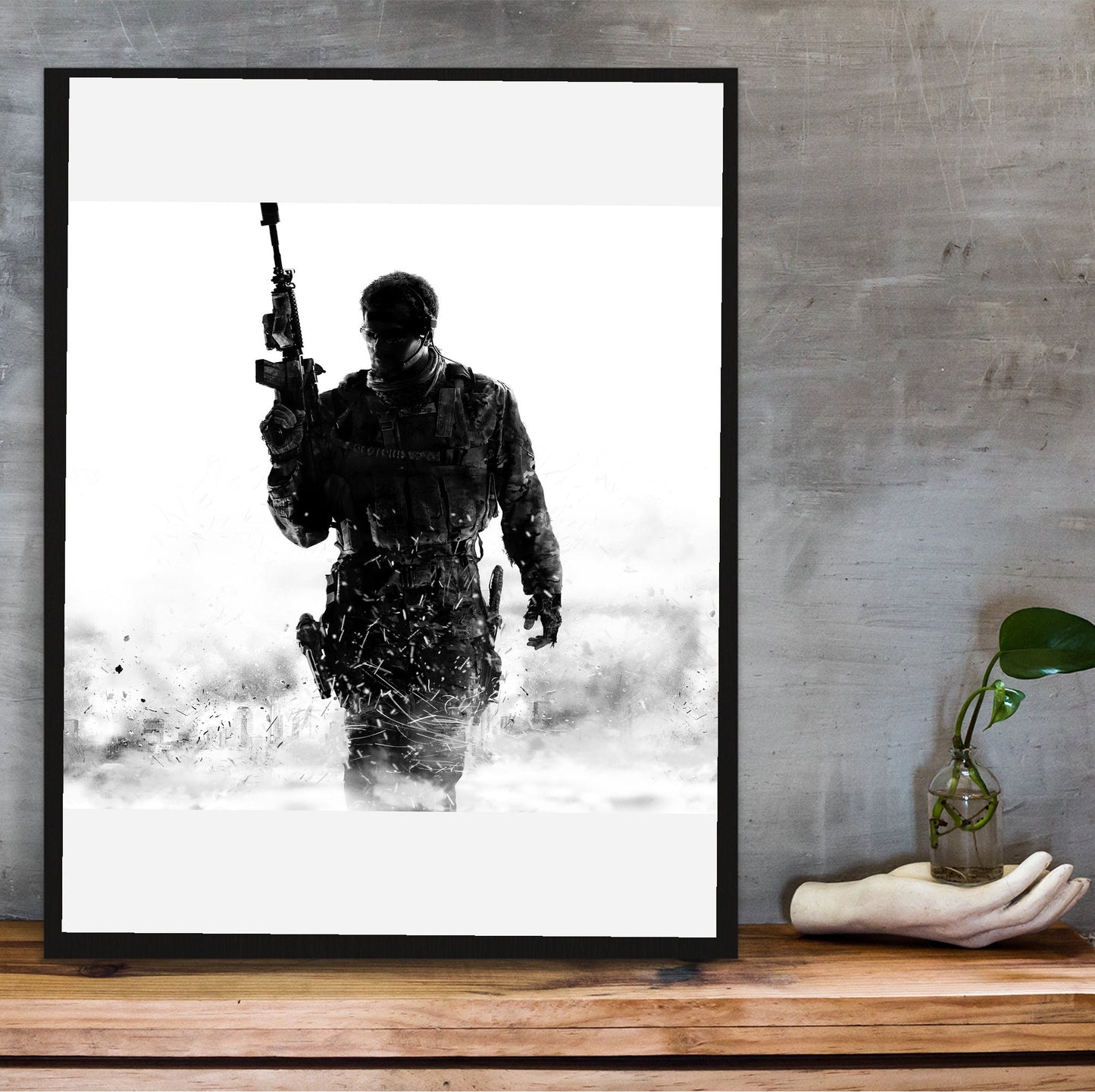 Call of Duty Modern Warfare 3 cover art in a black frame on a wooden shelf against concrete