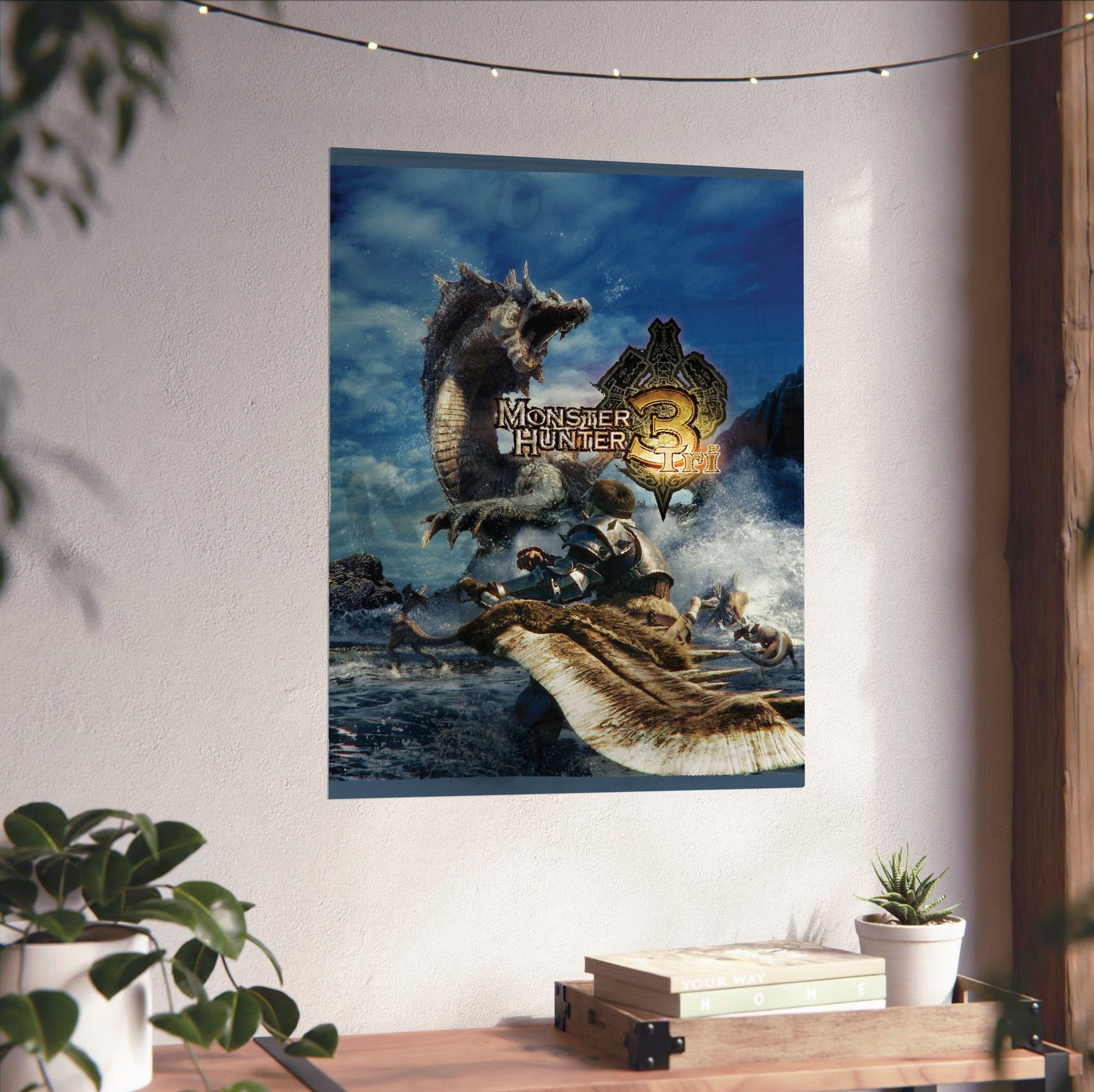 Monster Hunter Tri cover art with logo unframed on a white wall above a desk