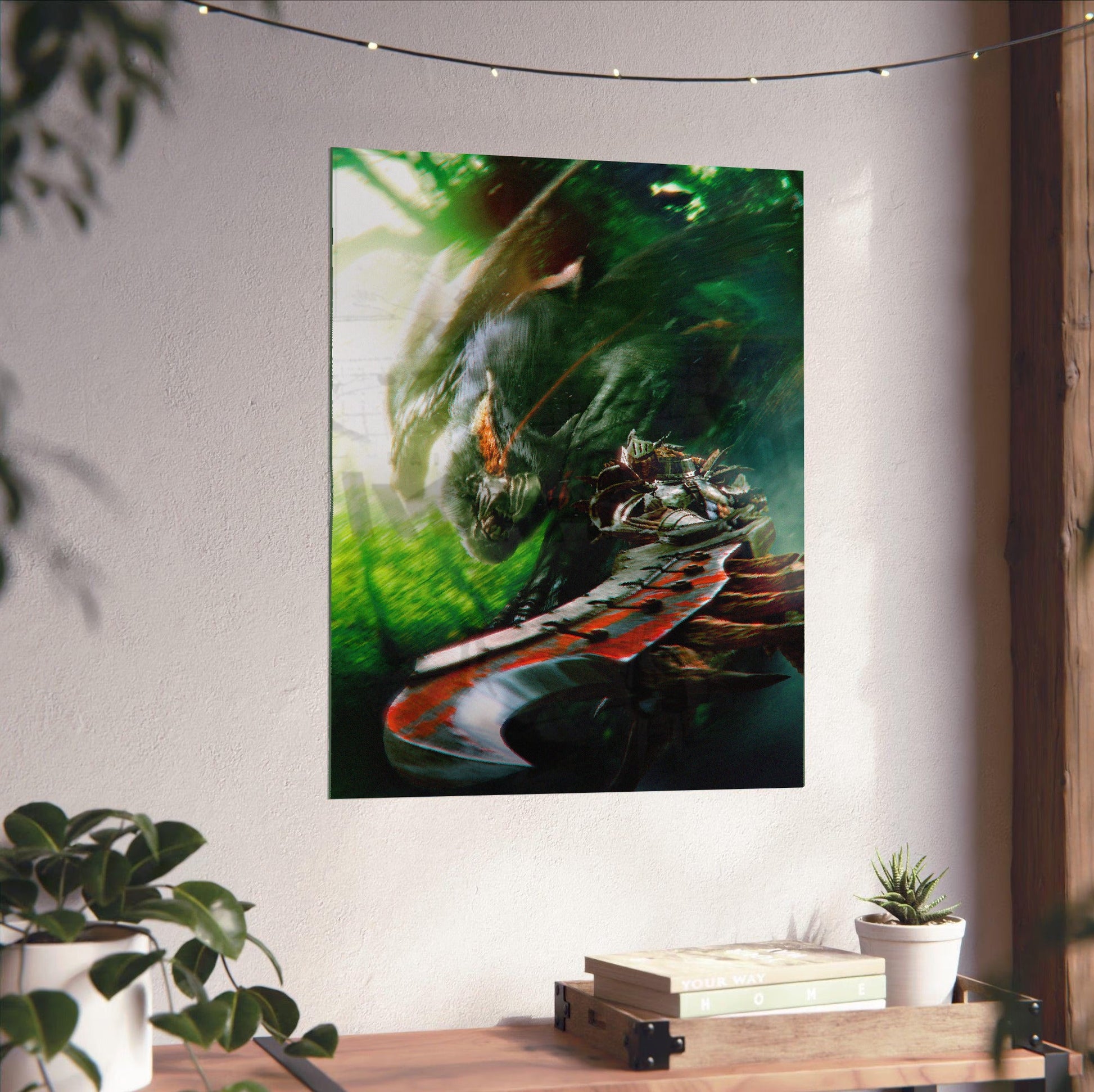 Monster Hunter Freedom Unite key art unframed on a white wall above a desk