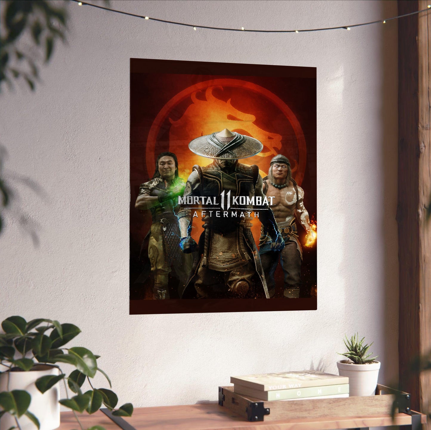 Mortal Kombat 11 Aftermath key art unframed on a white wall above a desk