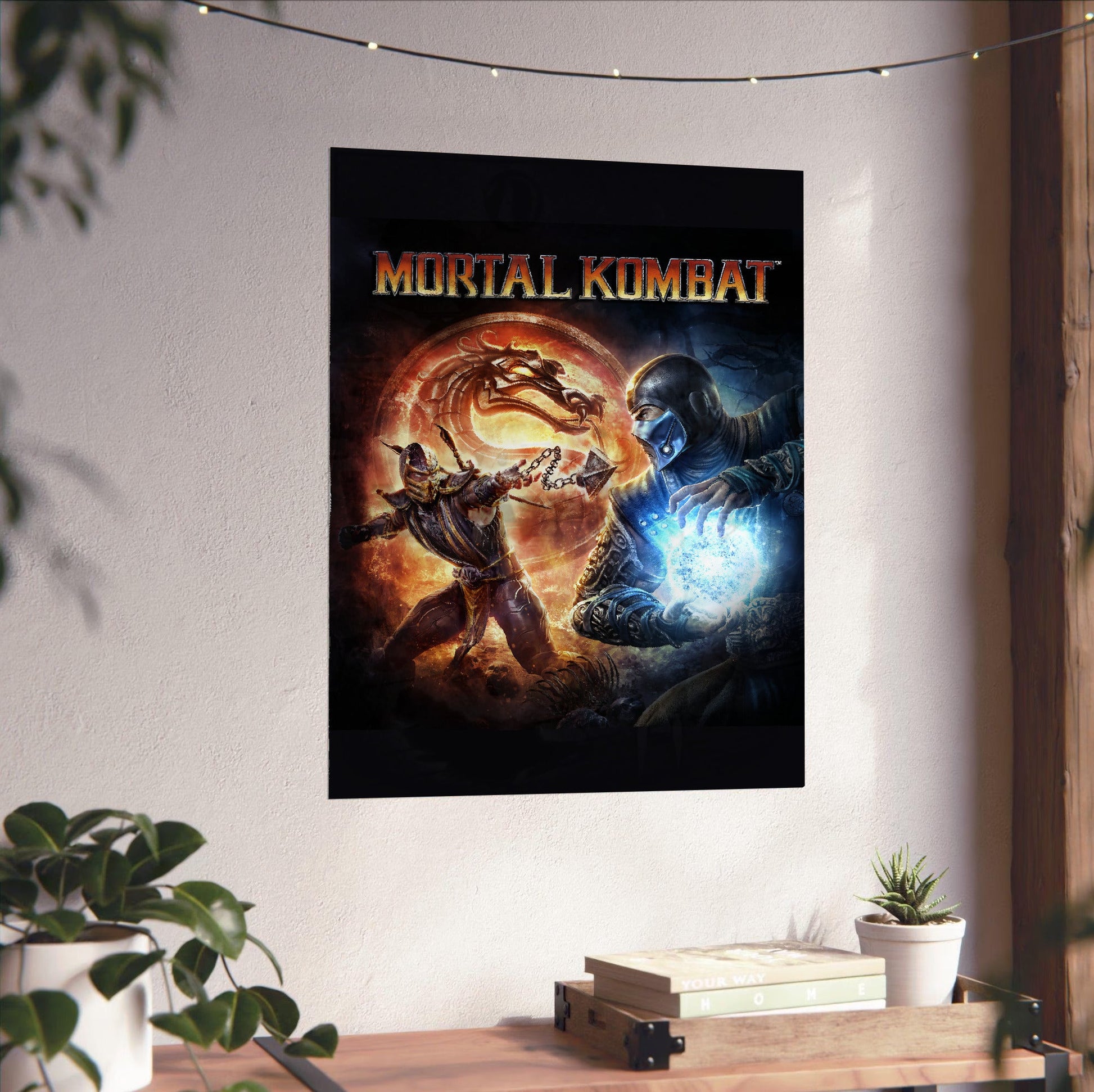 Mortal Kombat 9 cover art with logo unframed on a white wall above a desk