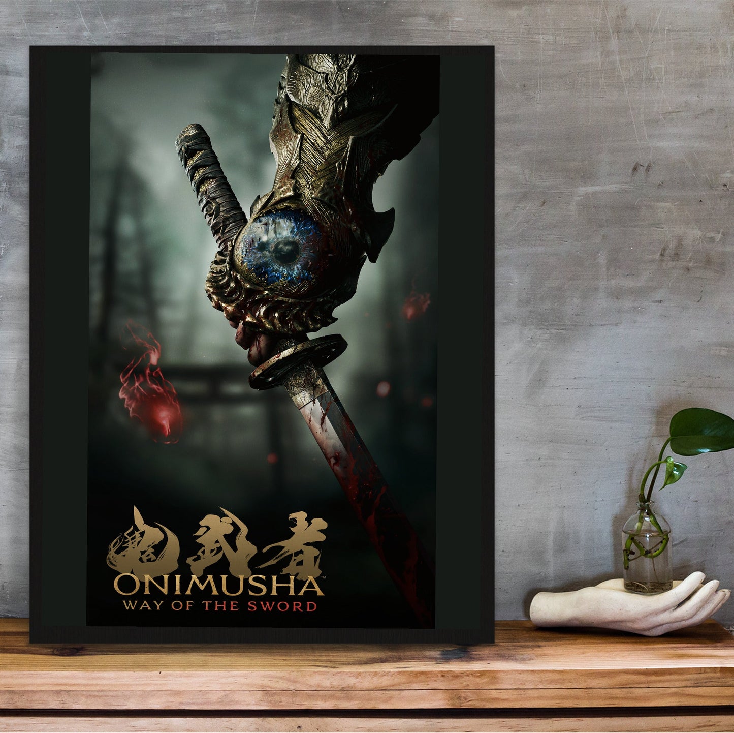 Onimusha Way of the Sword key art in a black frame on a wooden shelf against concrete
