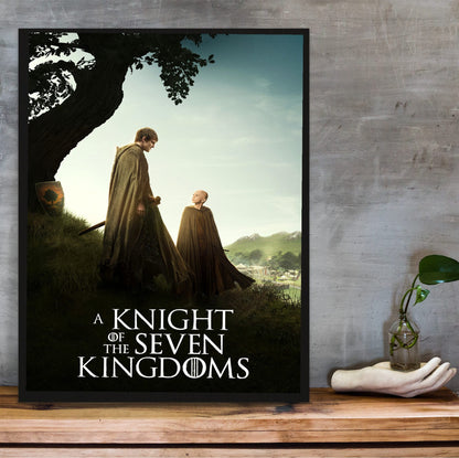 A Knight of the Seven Kingdoms Key Art poster in a black frame on a wooden shelf against concrete