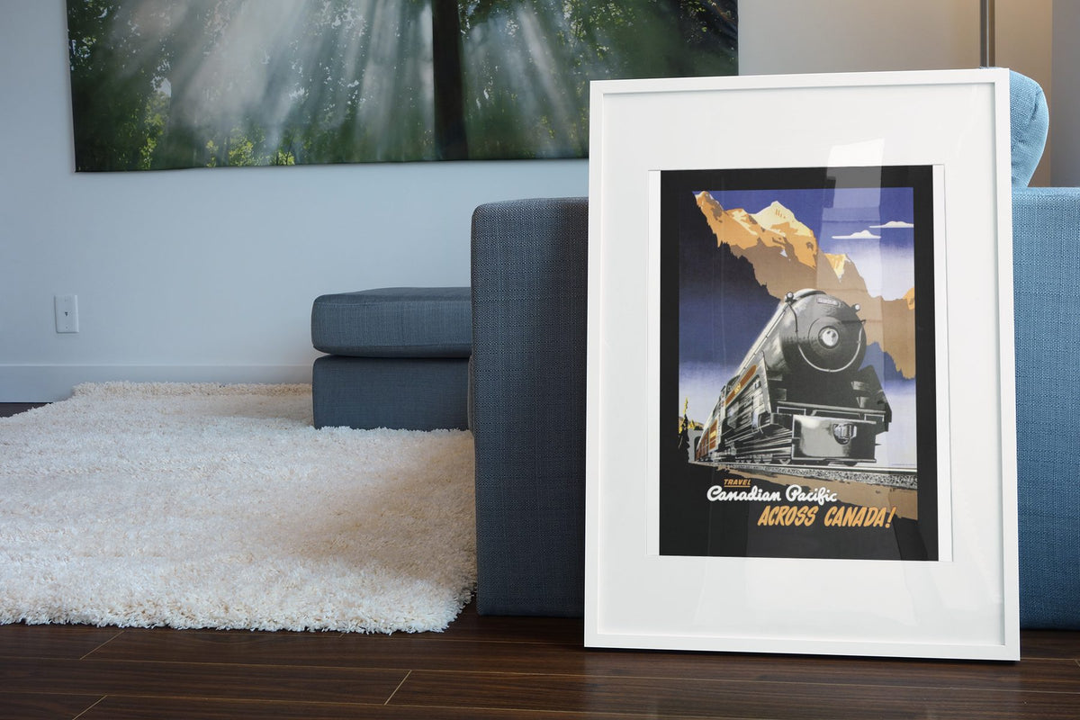Across Canada Canadian Pacific poster leaning beside a blue sofa