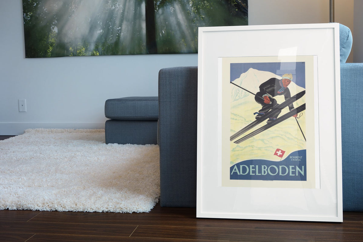 Adelboden Switzerland poster leaning beside a blue sofa