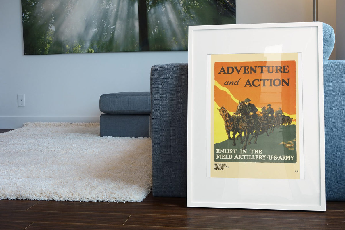 Adventure and Action — Field Artillery poster leaning beside a blue sofa