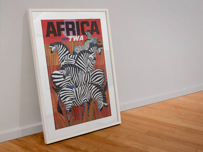 Africa Fly TWA poster in a white frame leaning against a wall