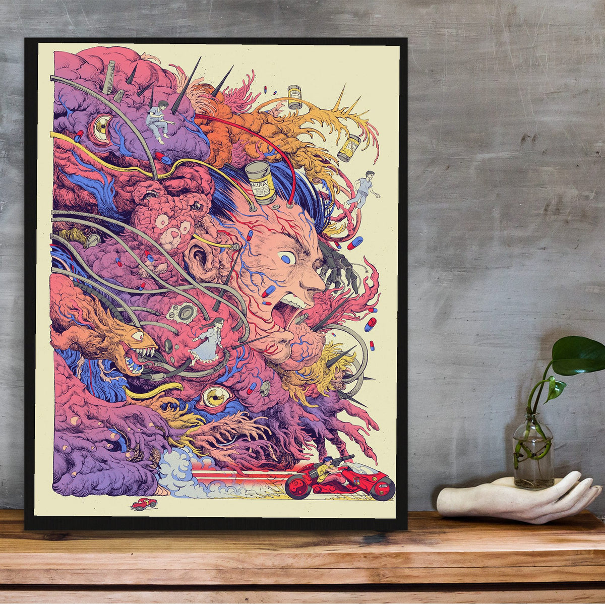 Akira (1988) Movie Logo Collage Art poster in a black frame on a wooden shelf against concrete