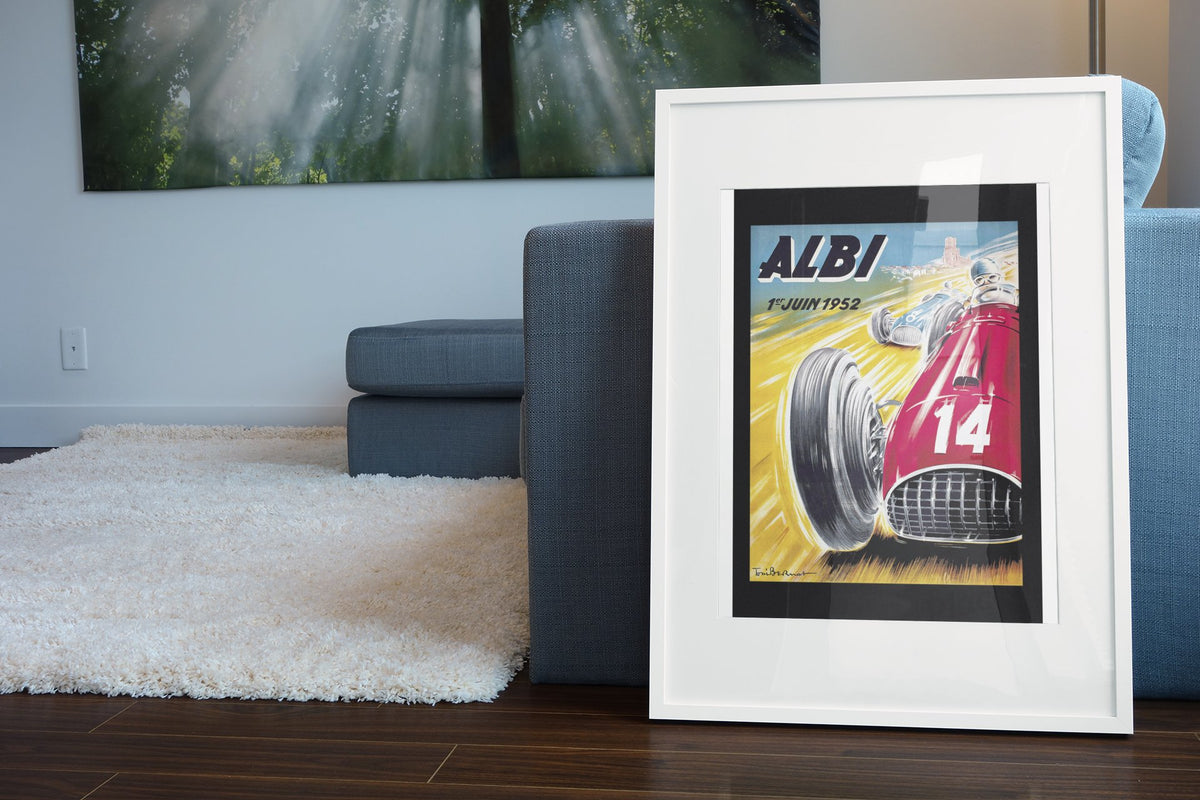 Albi Grand Prix 1952 poster in a white frame leaning beside a blue sofa